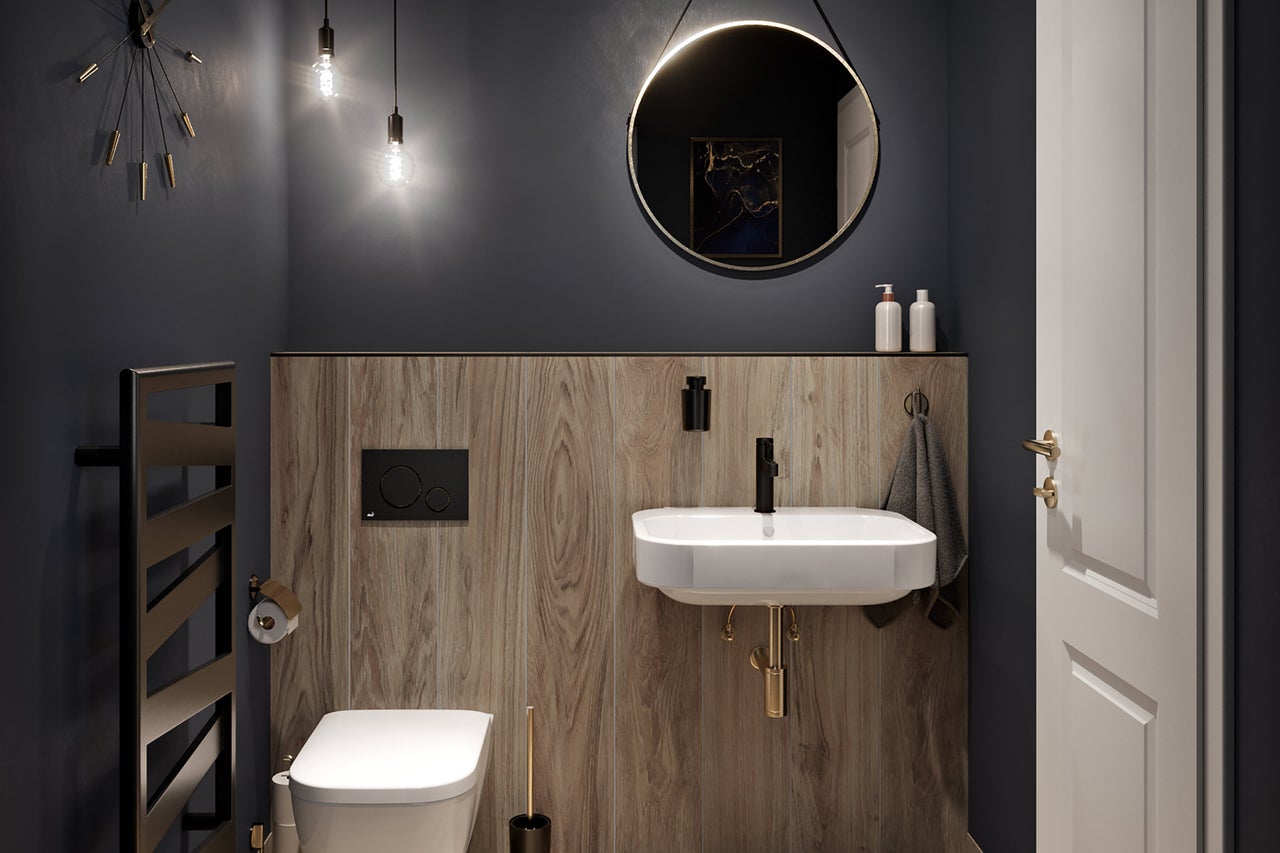 Modernt badrum med toalett, handfat, spegel och element