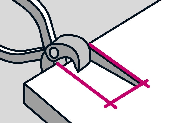 Avbitartång klipper en rosa linje på en vit yta