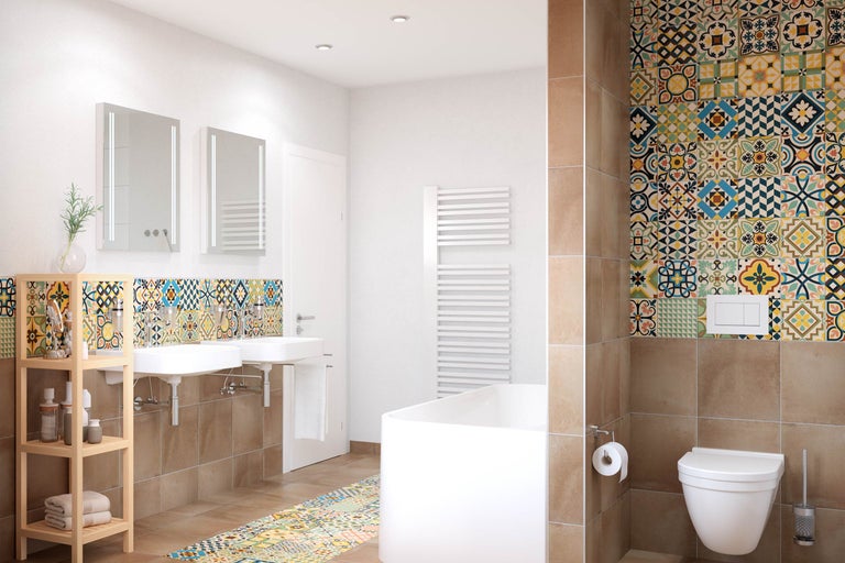 Ljust badrum med dubbla handfat, badkar, toalett och färgstark kakel