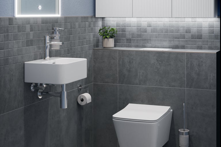 Badrum med handfat, toalett och gråa kakelplattor