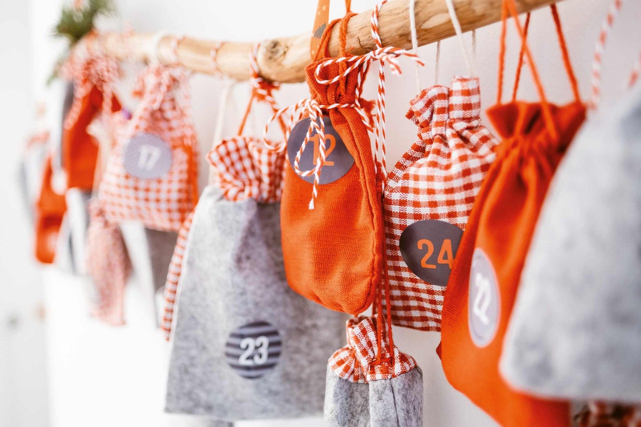 Adventskalender med tygpåsar, nummerskyltar och trästång