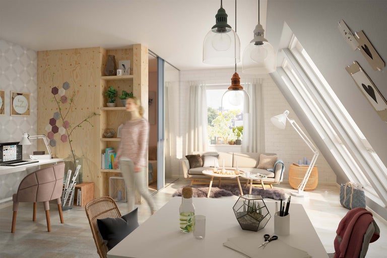 Ljust vindsvåningsrum med arbetsplats, sittgrupp och trähylla