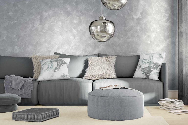 Grått vardagsrum med soffa, kuddar och lampor