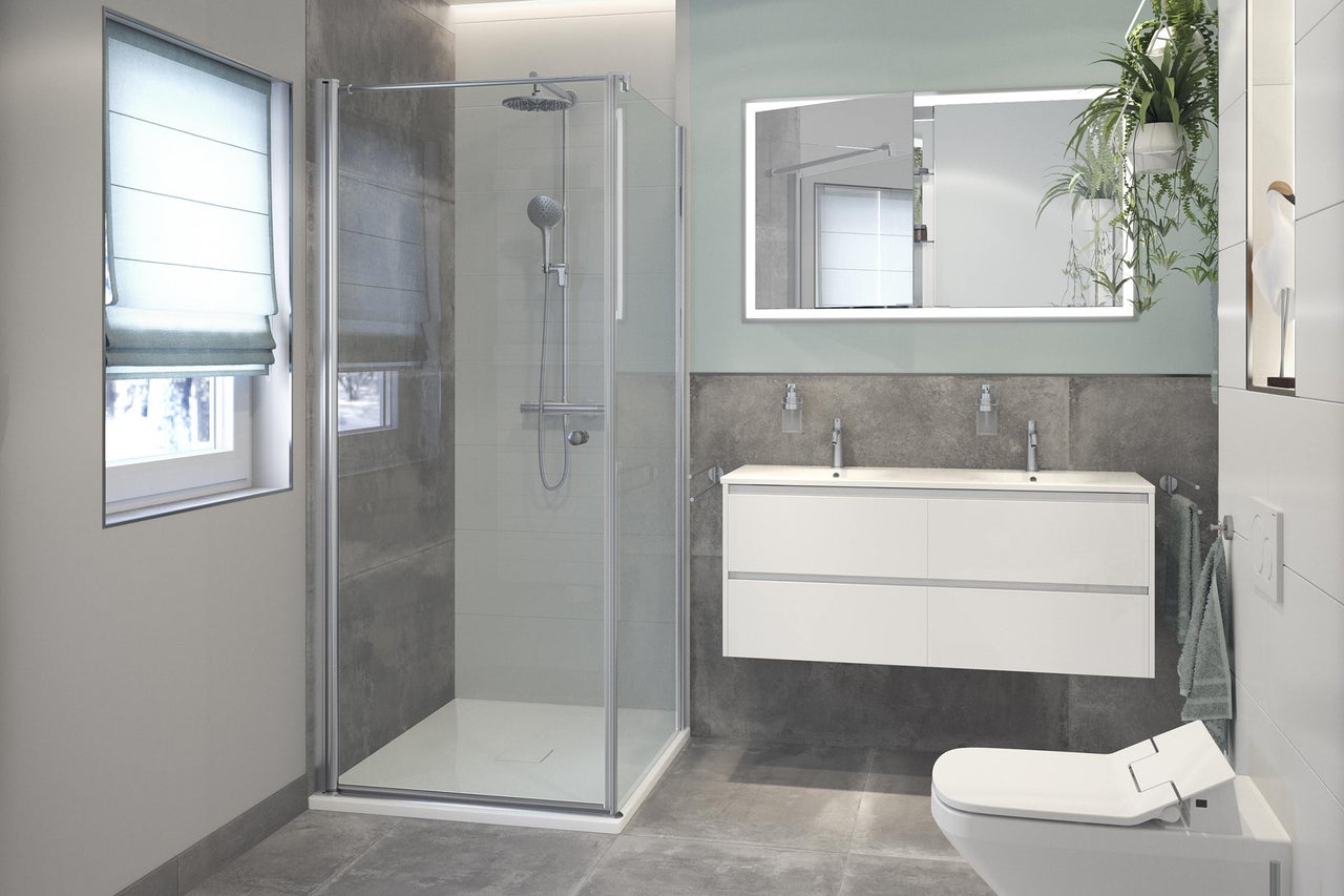 Modernt badrum med dusch, tvättställ och toalett.