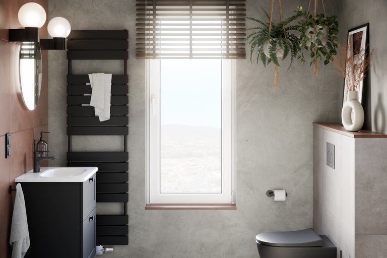 Modernt badrum med tvättställ, radiator, fönster och dekoration