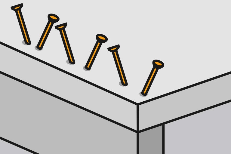 Illustration av inslagna spikar i trä