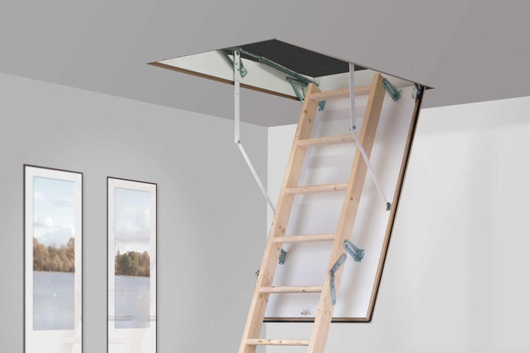 Utfälld trätrappa till vinden i ett rum.