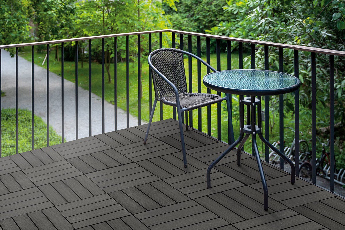 Bild av en balkong med stol, bord och trädgårdsplattor