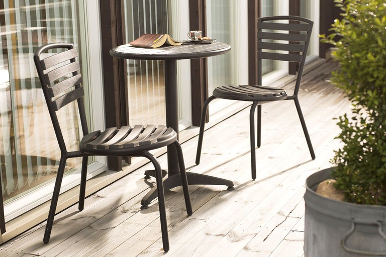 Uteplats med bord och två stolar på en terrass