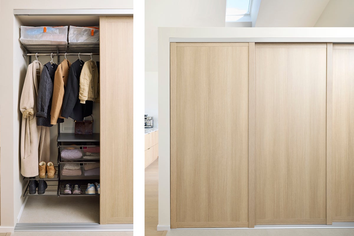 Öppen garderob med skjutdörrar, kläder och förvaringskorgar