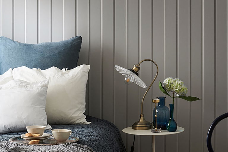 Dekorativt sovrum med säng, sänglampa och tillbehör