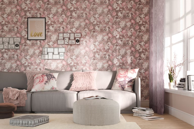 Vardagsrum med soffa, kuddar, pall, dekoration och blommig tapet