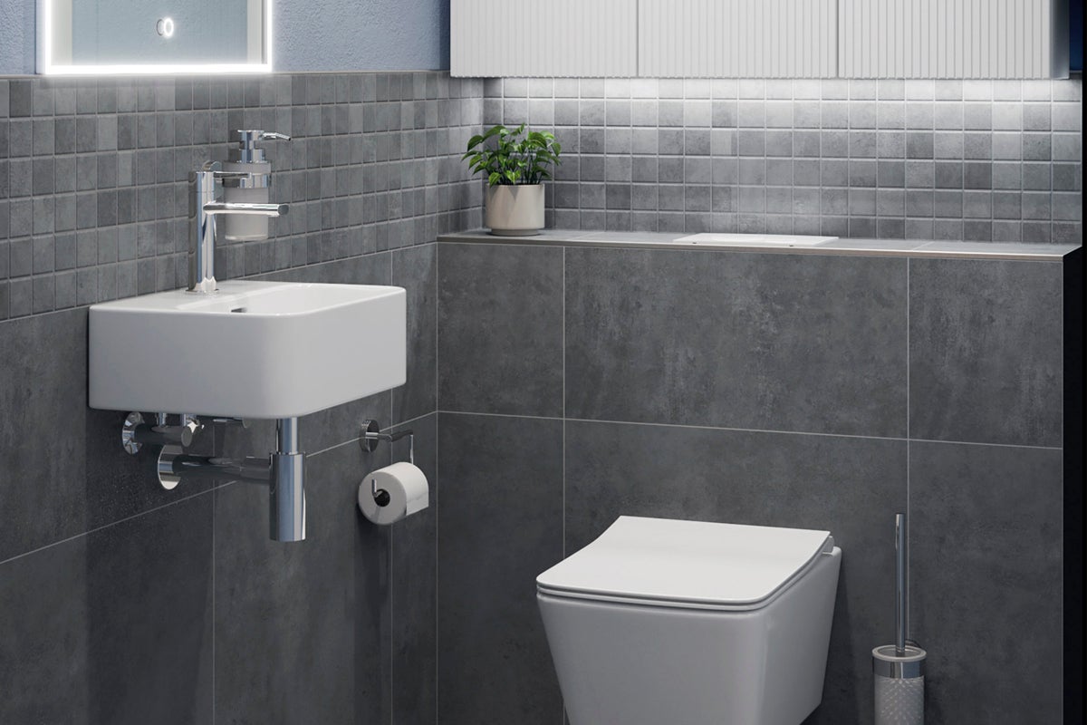 Modernt badrum med handfat, toalett och grå kakel