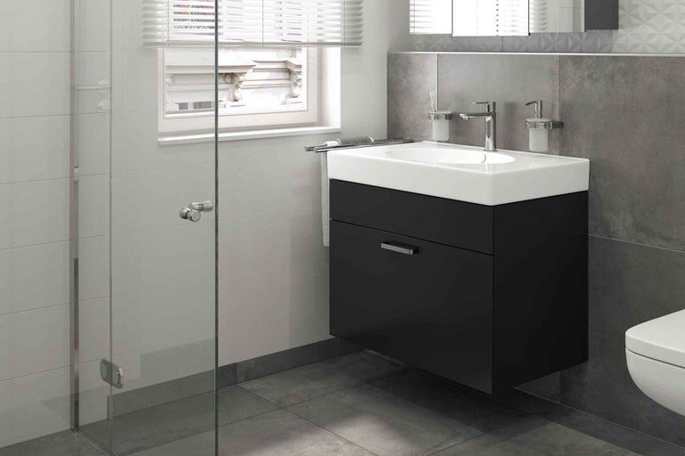 Badrum med tvättställsskåp, armatur och handdukshållare