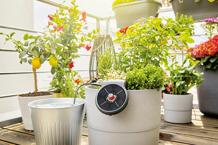 Balkongscen med växter i krukor och automatiskt bevattningssystem