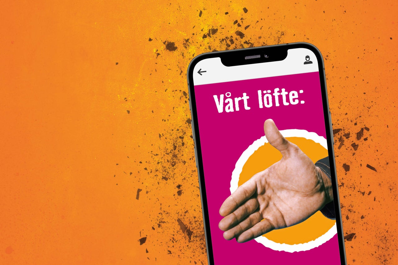 Mobiltelefon med texten Vårt löfte och en hand som skakar