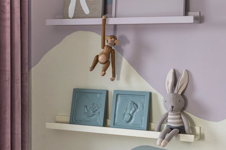 Barnrumsinredning med träleksak apa, handavtryck och fotavtryck