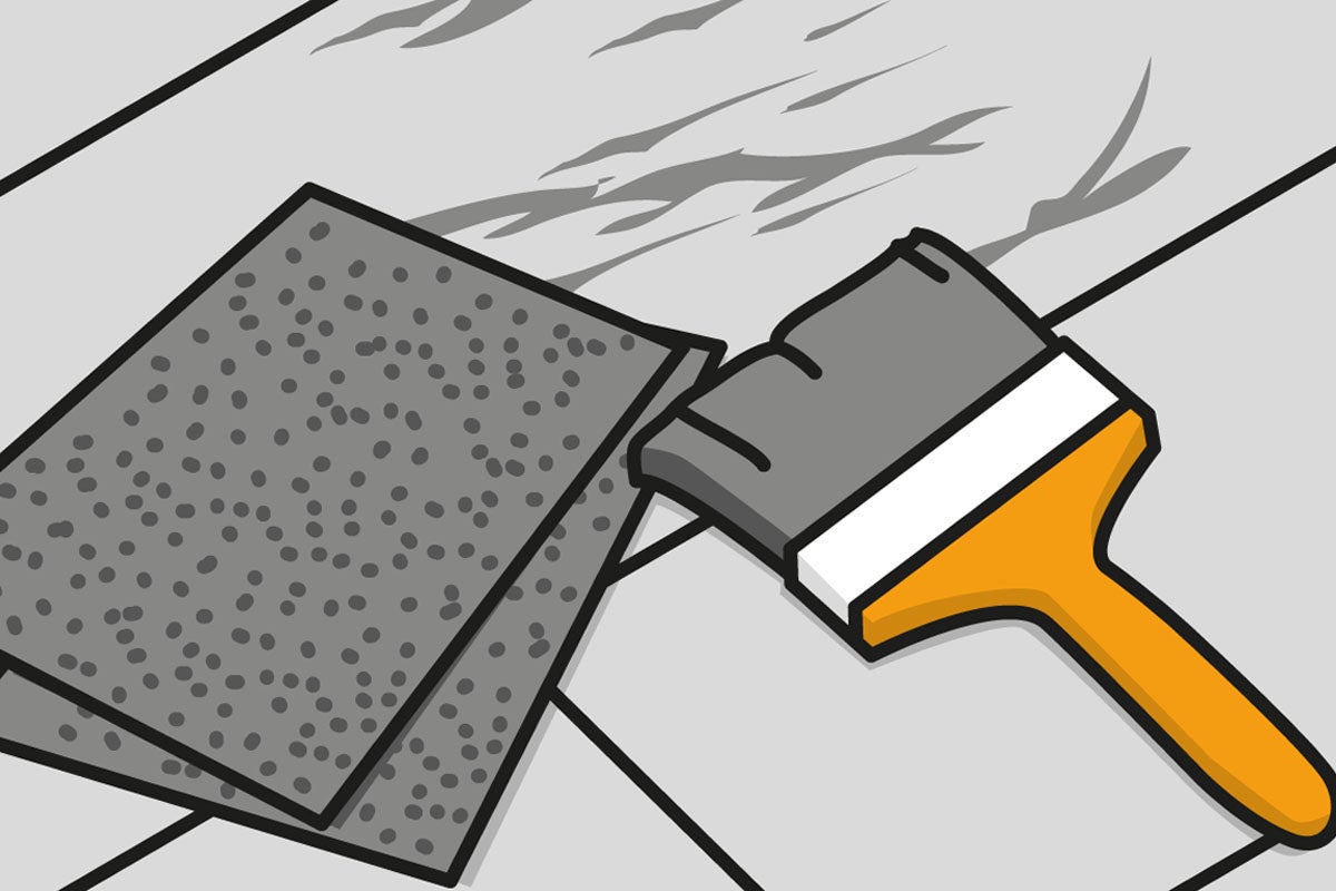 Två ark sandpapper och en pensel på en yta