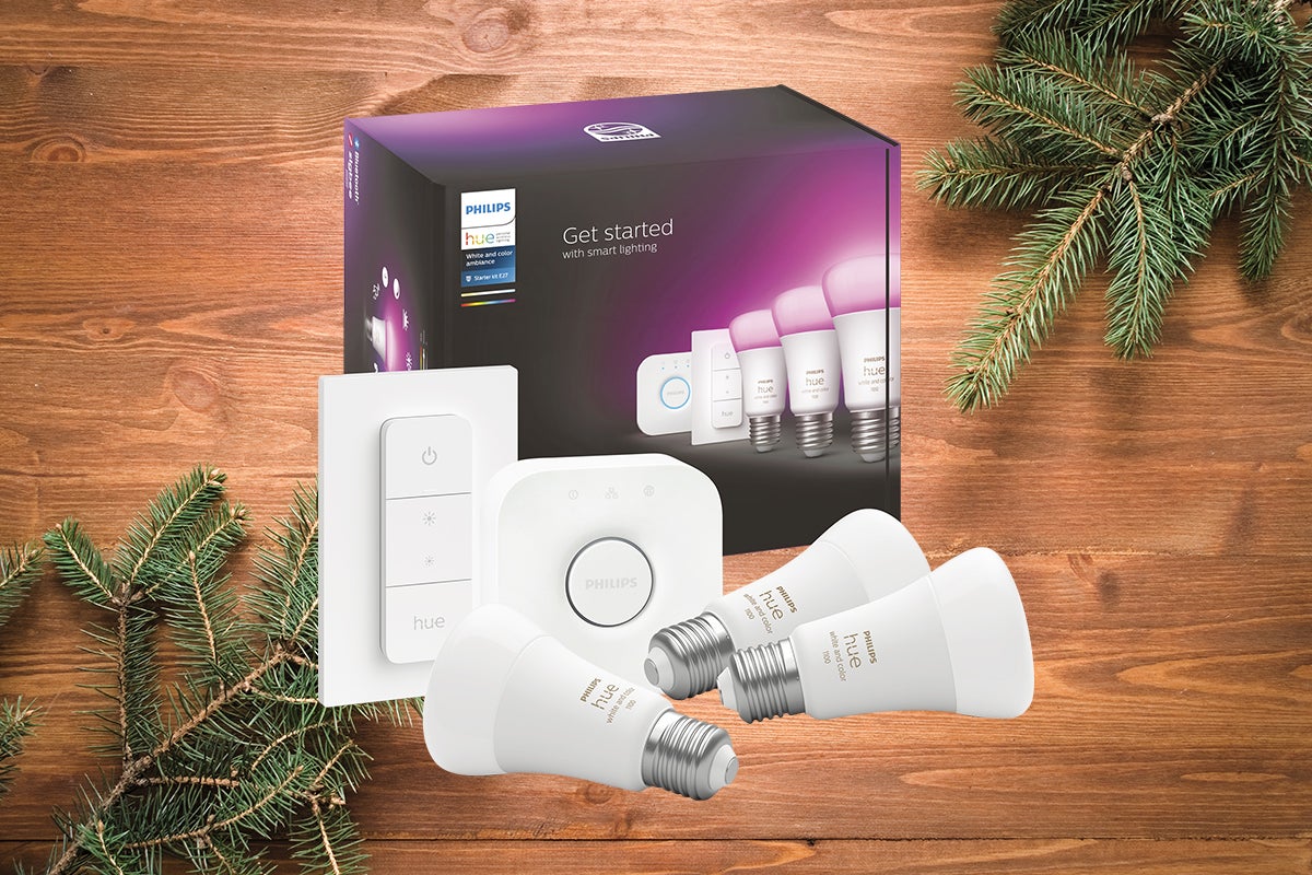 Philips Hue startpaket med glödlampor, brygga och dimmer på ett träbord