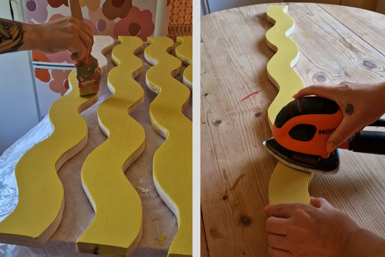 Person målar och slipar vågformade träbitar.