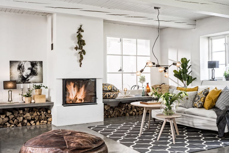 Vardagsrum med öppen spis, soffa, soffbord och dekoration