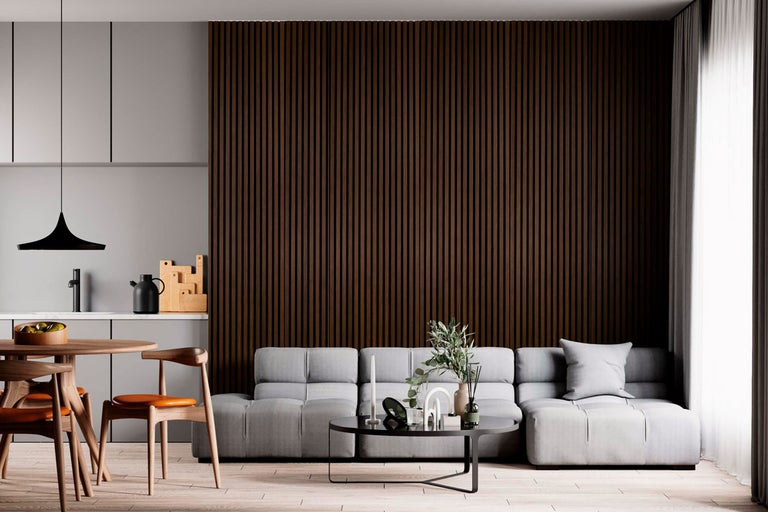 Vardagsrum med grå soffa, träbord och väggpanel i trä