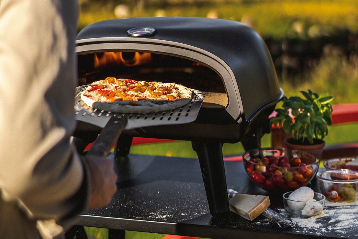 Pizza bakas i en pizzaugn utomhus