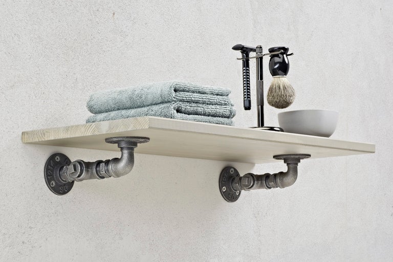 Hylla med handdukar och rakartiklar på en vägg