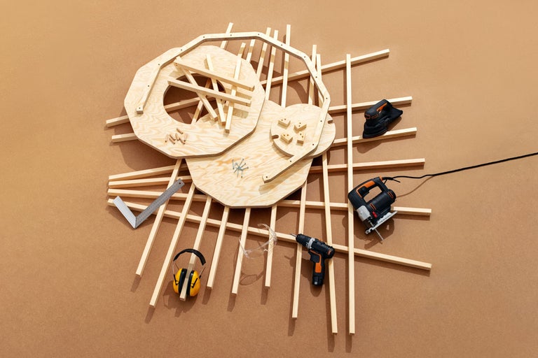 Arbetsbänk bygginstruktioner med trä, skruvar, hörselskydd, vinkel, borrmaskin, slipmaskin och sticksåg