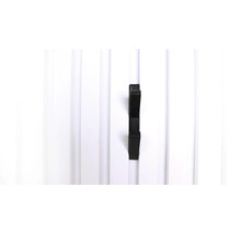 Svart klädkrok på vit trävägg