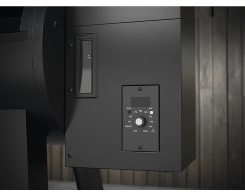 Närbild av en svart pelletgrill med temperaturregulator och visningsfönster