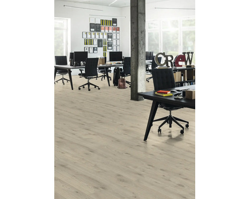 Ljust kontorsutrymme med trägolv, skrivbord och kontorsstolar.