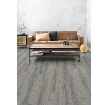 Vardagsrum med grått trägolv, soffa och soffbord