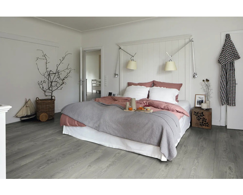 Ljust sovrum med säng, sängbord och trägolv