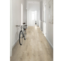 Hall med ljust trägolv, vita väggar och en cykel