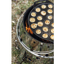 Poffertjespanna på en kolgrill med eld.