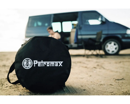 Petromax bärväska framför en husbil på stranden
