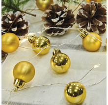 Dekorativ ljusslinga med gyllene kulor och kottar