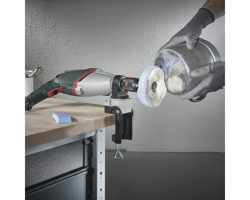 Borrmaskin med poleringstillbehör och skruvstäd på arbetsbänk som polerar en metallhink