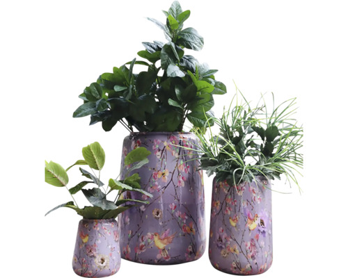 Tre planterade ytterkrukor med blommönster