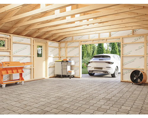 Oavslutat garage med verktygsvagn, mobilt verktygsskåp och parkerad bil