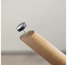 Möbelglidare med spik på ett träben