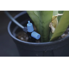 Bevattningssystem med justeringskran i en blomkruka