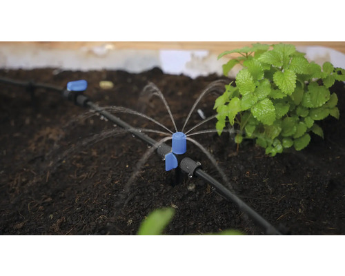 Bevattningssystem med sprinkler i en trädgårdsrabatt