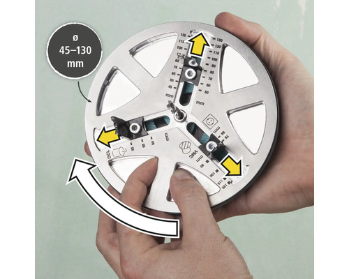 Ett verktyg för exakt markering av borrhål med en diameter på 45 till 130 millimeter hålls av två händer.