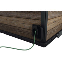 Detaljvy av ett trädgårdshus med elanslutning och kabel