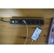 Grenuttag med överspänningsskydd och en ansluten smartphone