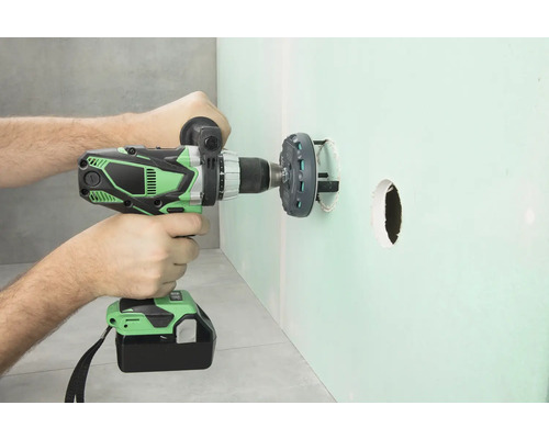 Sladdlös borrmaskin borrar ett hål i en vägg