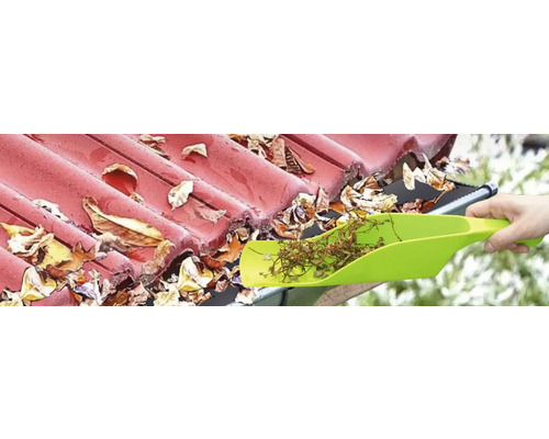 Rengöring av en takränna med en spade för att ta bort löv