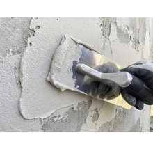 Applicering av puts med spackel på en vägg